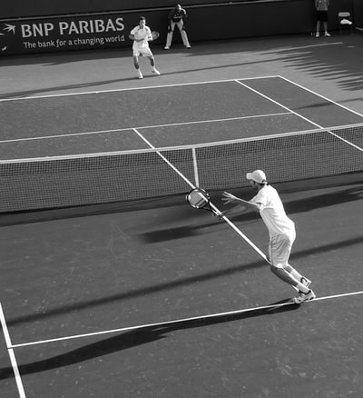 Two men play lawn tennis grayscale images
